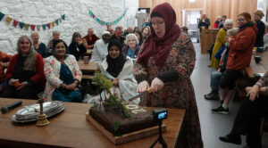 Guests at Iona Abbey cut a cake.