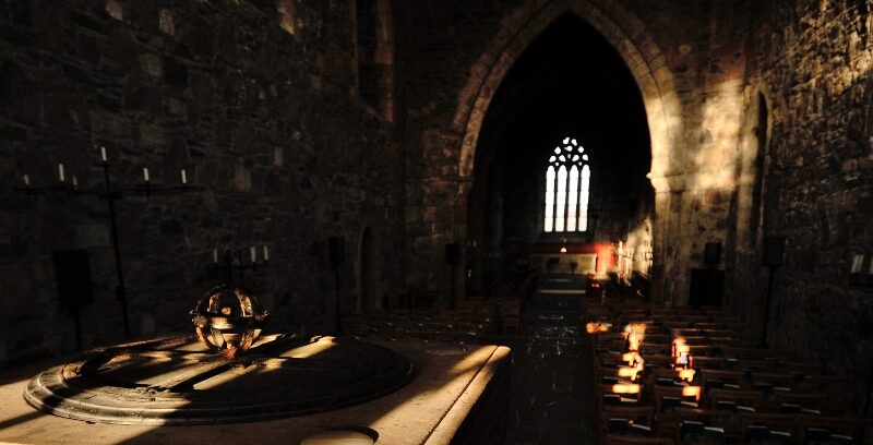 Light shines through a window on to the floor of Iona Abbey.