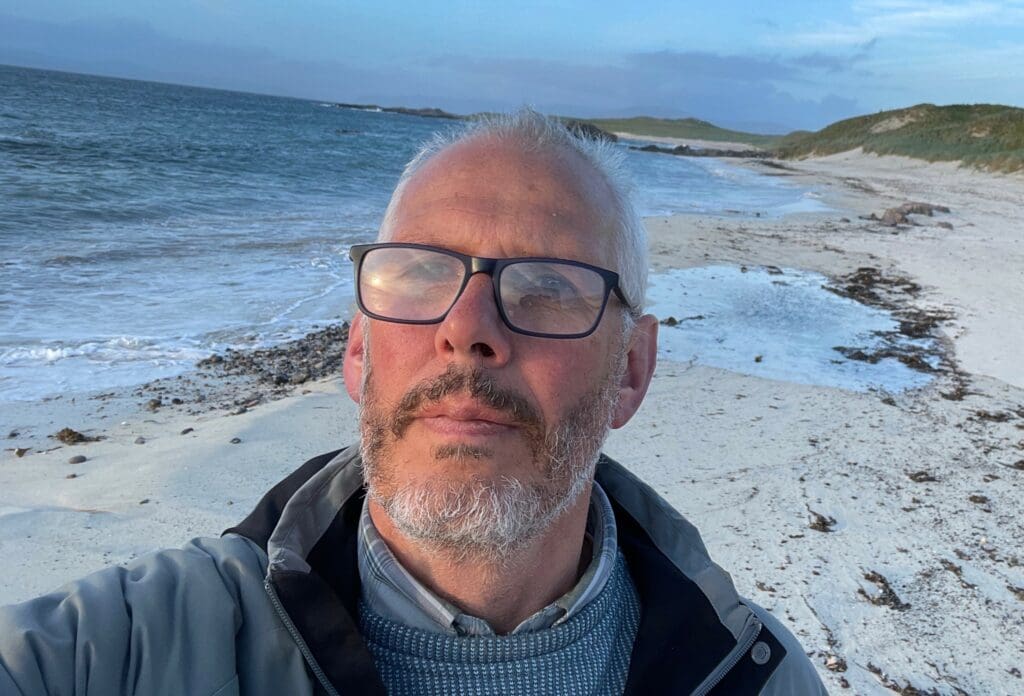 Picture of Chris Mannall on a beach