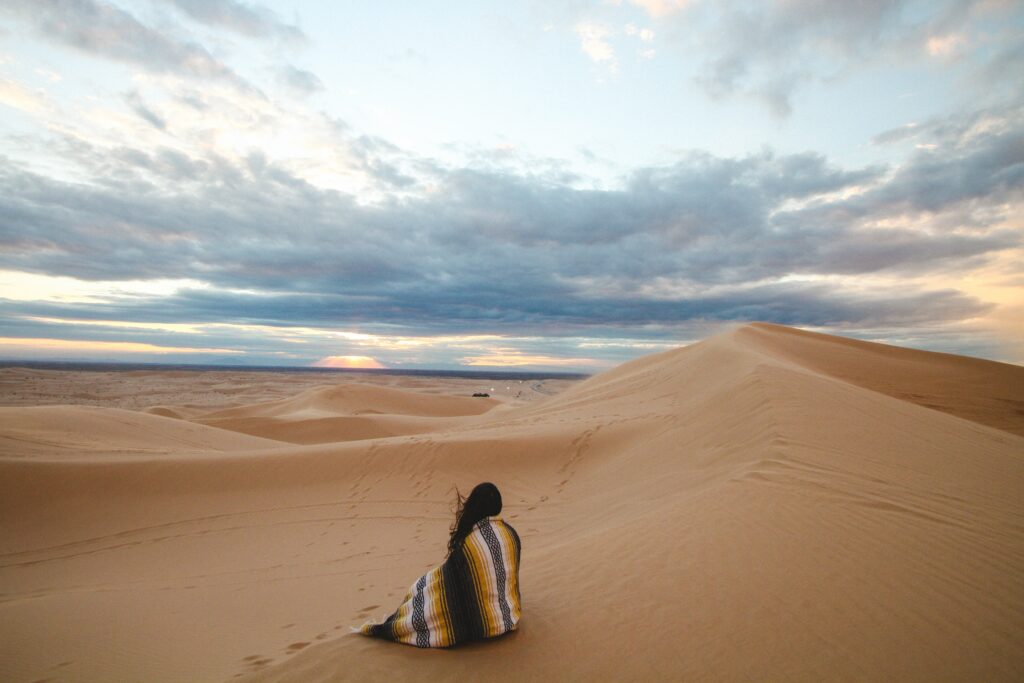 Person sitting in the desert