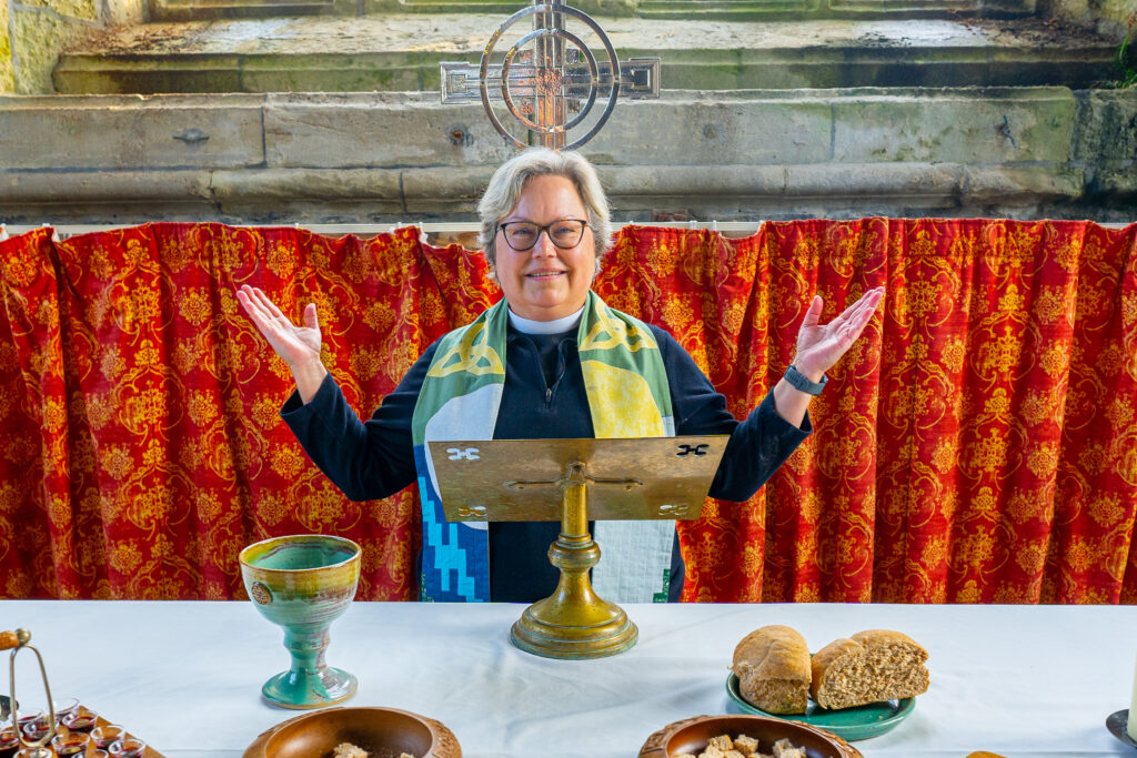 Rev Kathy Kelly precedes over communion at Iona Abbey