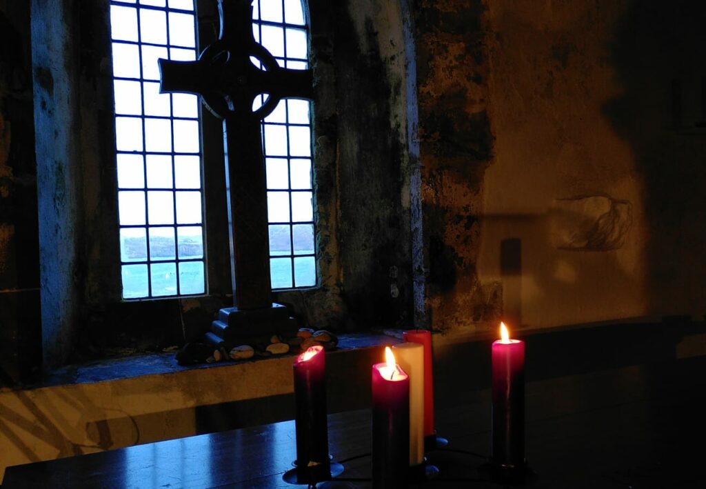 Three lit Advent Candles in the Michael Chapel on Iona
