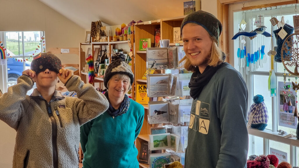 Three people in the Welcome Centre and Shop