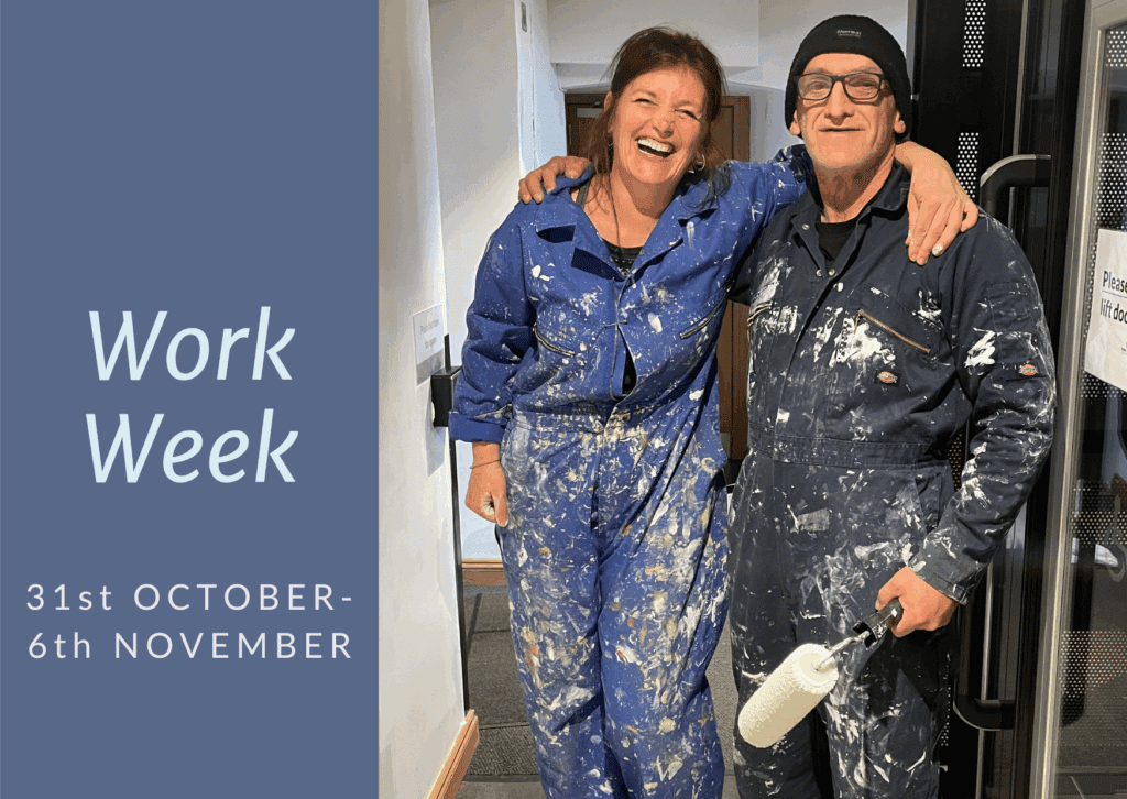 Winter Work Week, two people in overalls and painting walls in the Abbey.