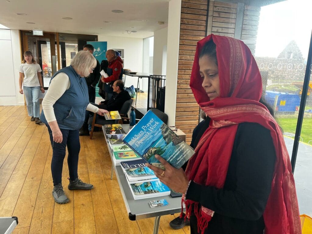 Woman in a headscarf reads a book.