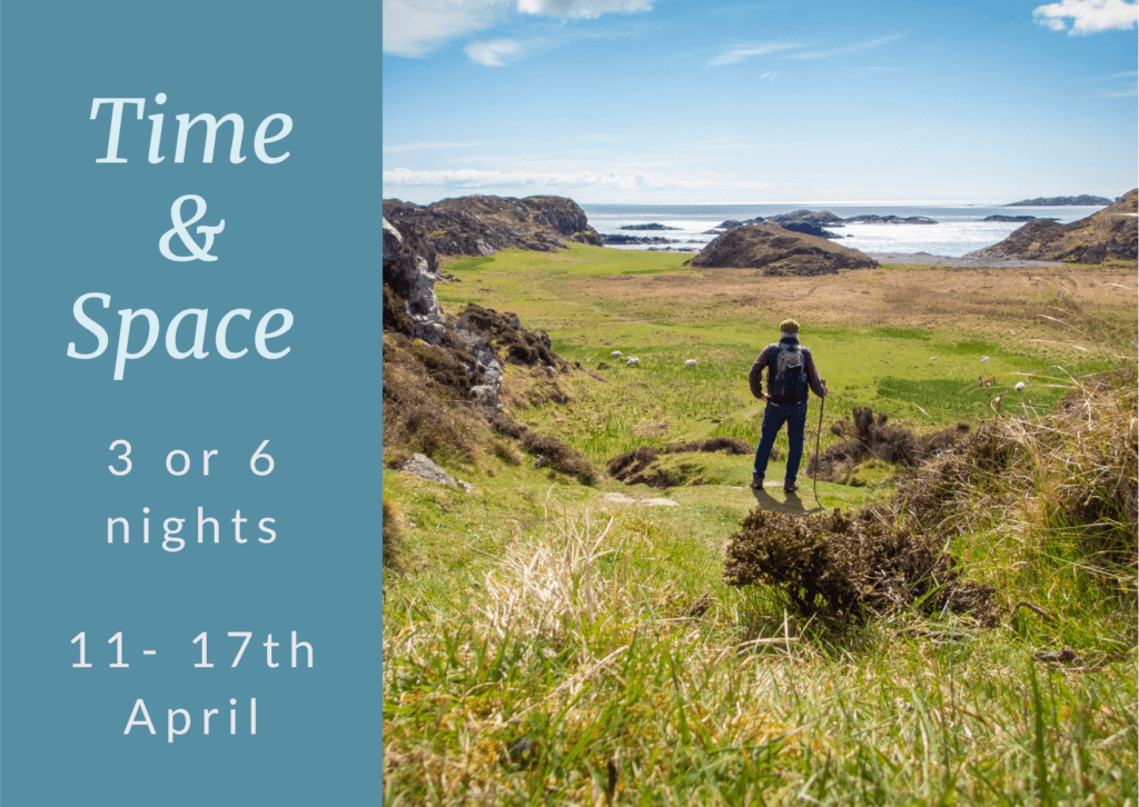 Person looking down into Columba's Bay on Iona.